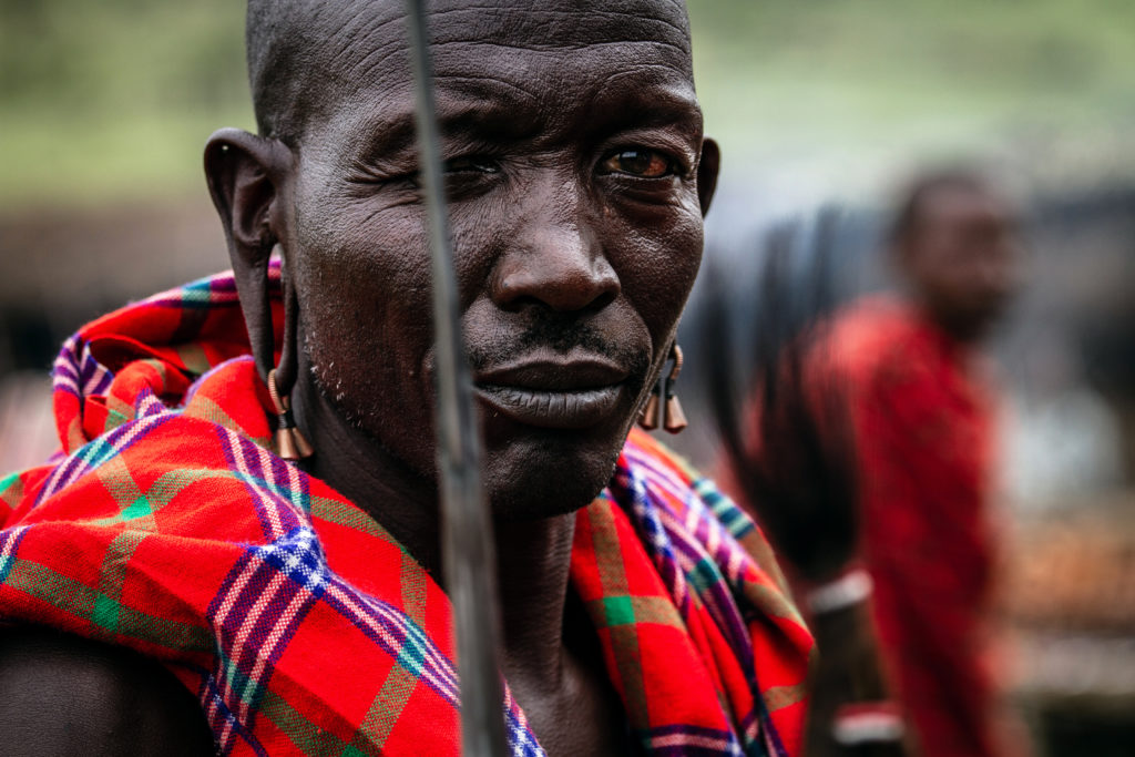 This is a Kenyan, Maasai warrior in traditional clothes. It is a Spring Equinox image as it relates to the warrior archetype of the sign Aries.